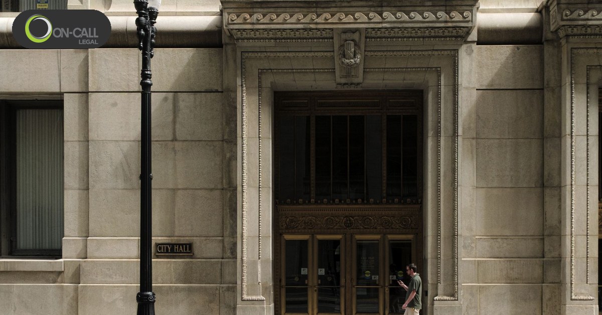 The entrance to a city hall, where the city clerk accepts service for the city