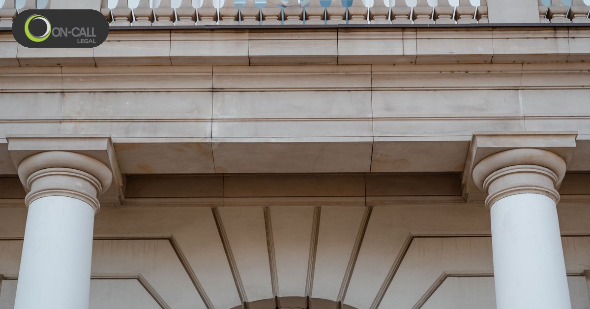 The columned entrance of a government building seen from below