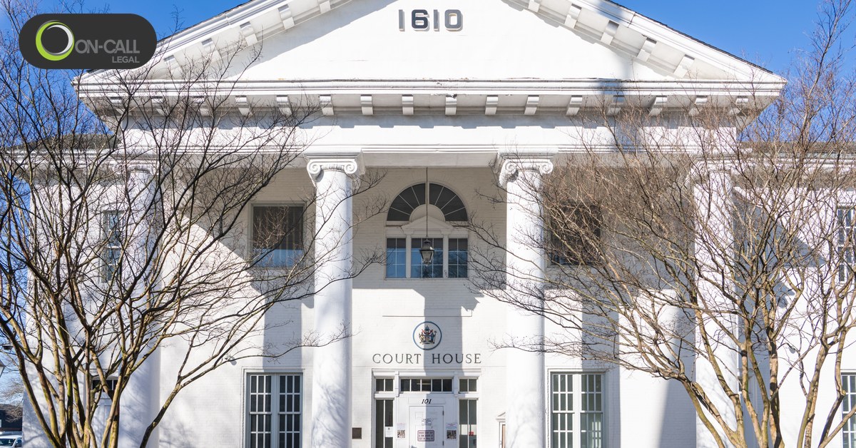 The columned front of a historic courthouse on a clear day