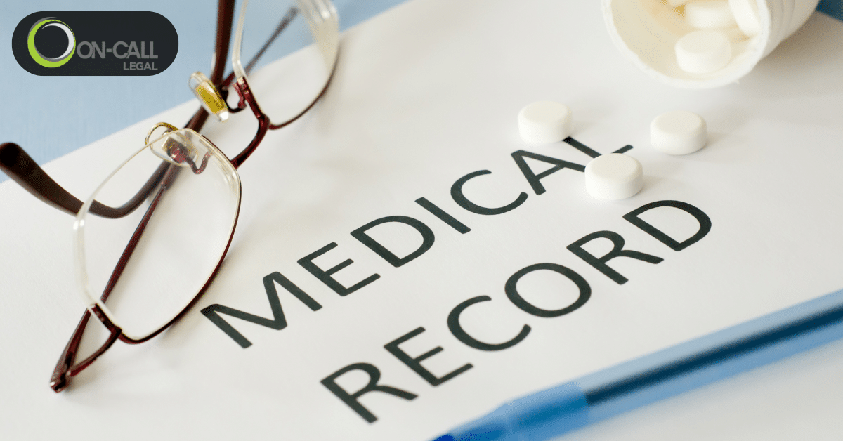 A patient medical record file with reading glasses and prescription medication on a desk